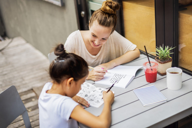 Smiling teacher with student learning French