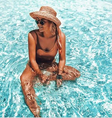 Woman In The Ocean Wearing A Swimsuit From Bali Boat Shed