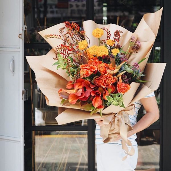 Woman Holding A Bouquet By Floral Magic Singapore