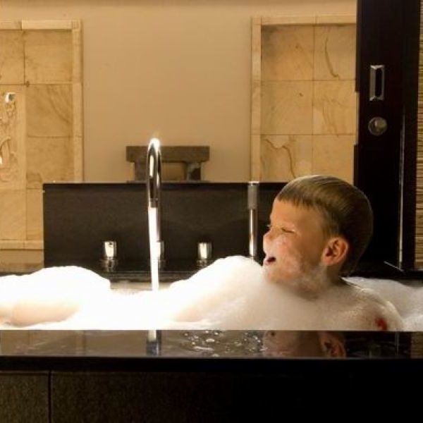 Child Playing In The Tub At Jiwa Spa At Conrad Bali