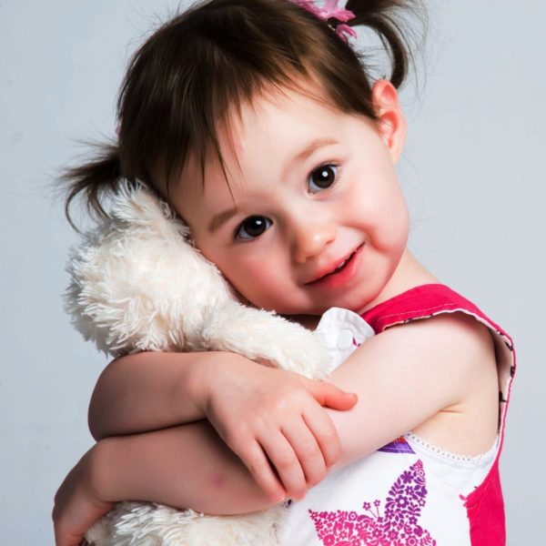 Girl Holding A Toy
