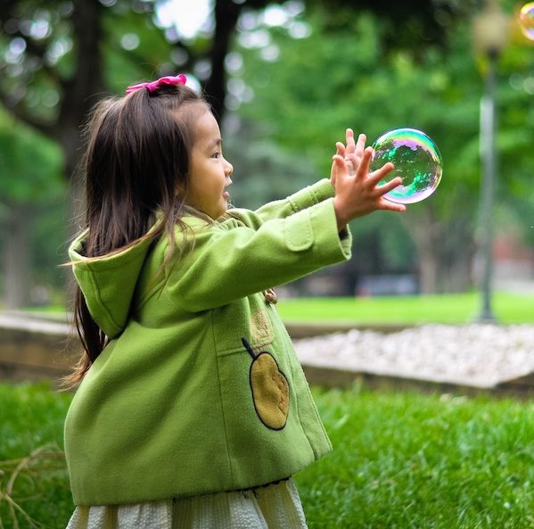 Little Girl Playing With Bubbles