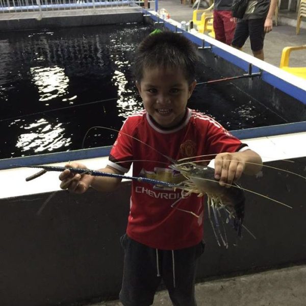Child Holding A Prawn From Riviera Prawn Fishing Singapore