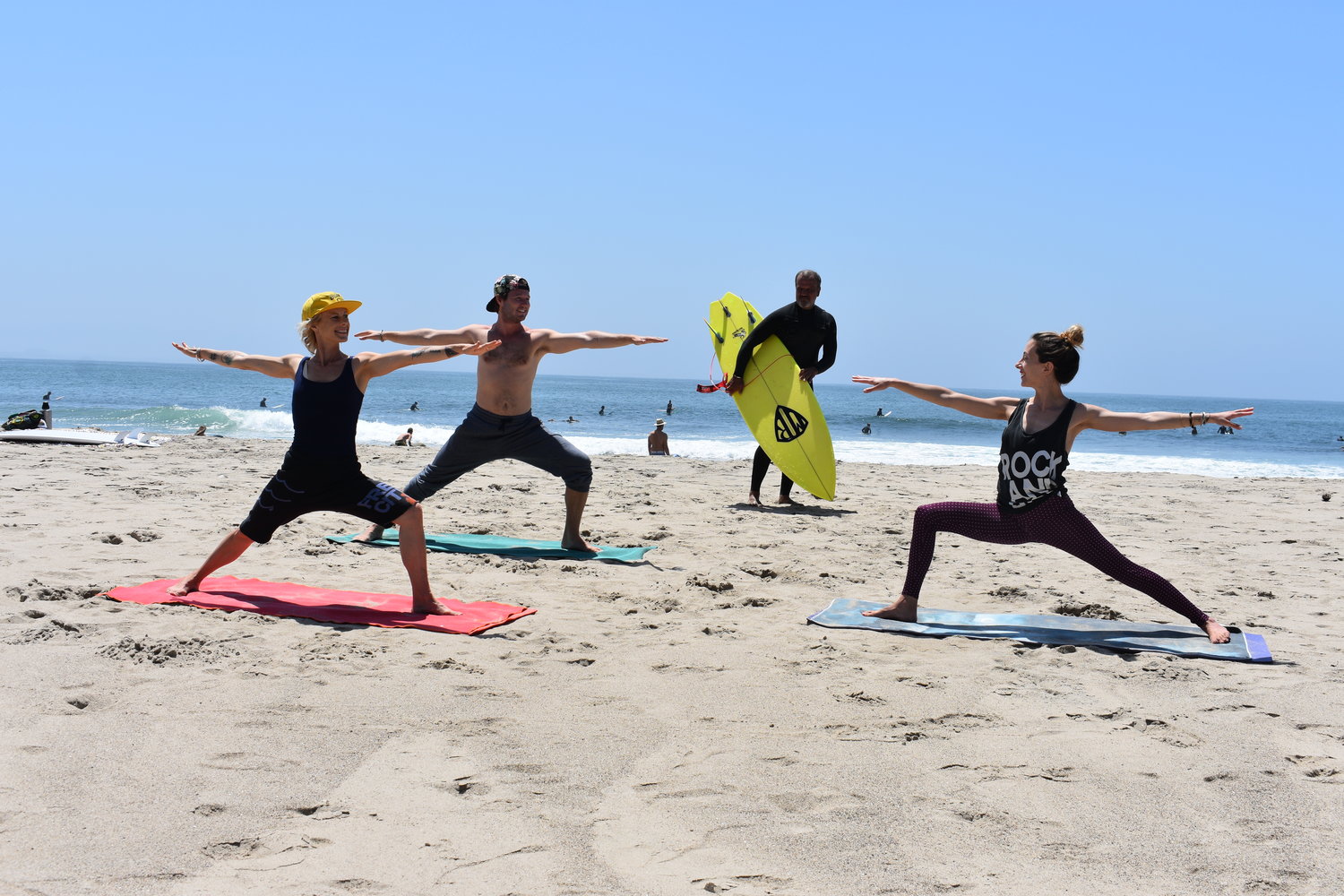People Doing Yoga At The Beach
