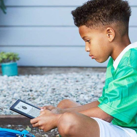 Kid reading Kindle