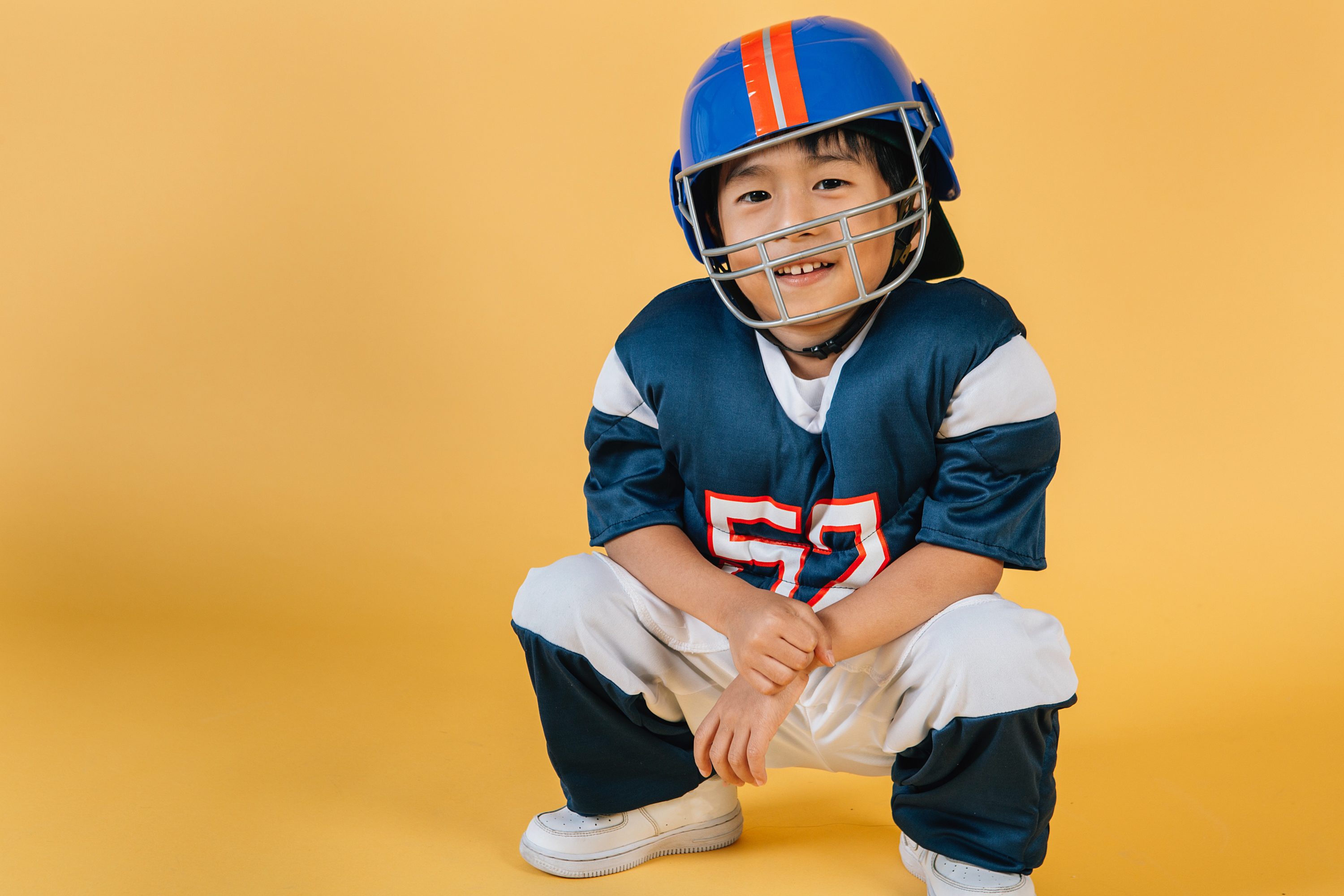 Boy in football gear top sports classes for kids jakarta